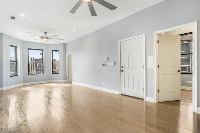 empty room with recessed lighting, baseboards, wood finished floors, and a ceiling fan