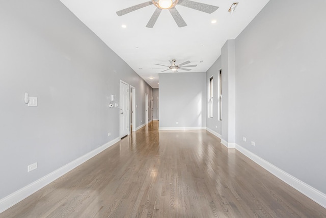 spare room with recessed lighting, baseboards, wood finished floors, and a ceiling fan