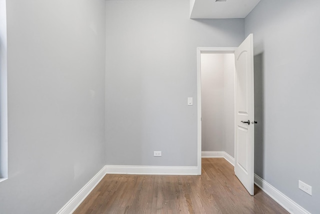 unfurnished room featuring baseboards and wood finished floors
