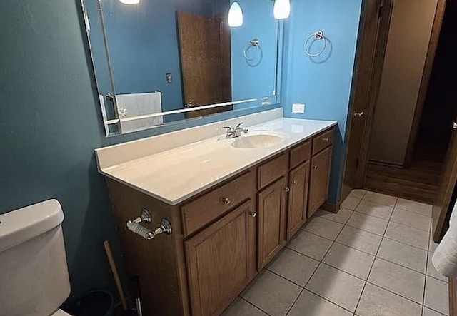 bathroom featuring tile patterned floors, toilet, and vanity