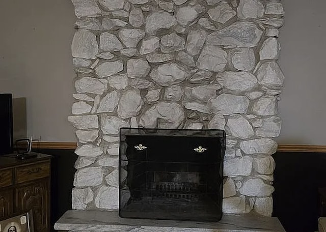 interior details with a stone fireplace