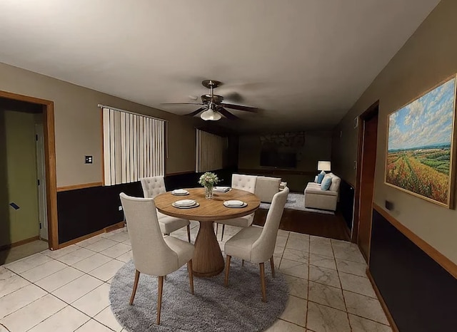 dining area with a ceiling fan and baseboards