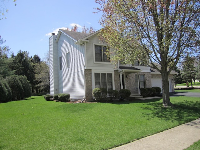 106 Tygert Ln, Dekalb, IL 60115 - view of front of property featuring brick siding, a chimney, a front yard, and an attached garage