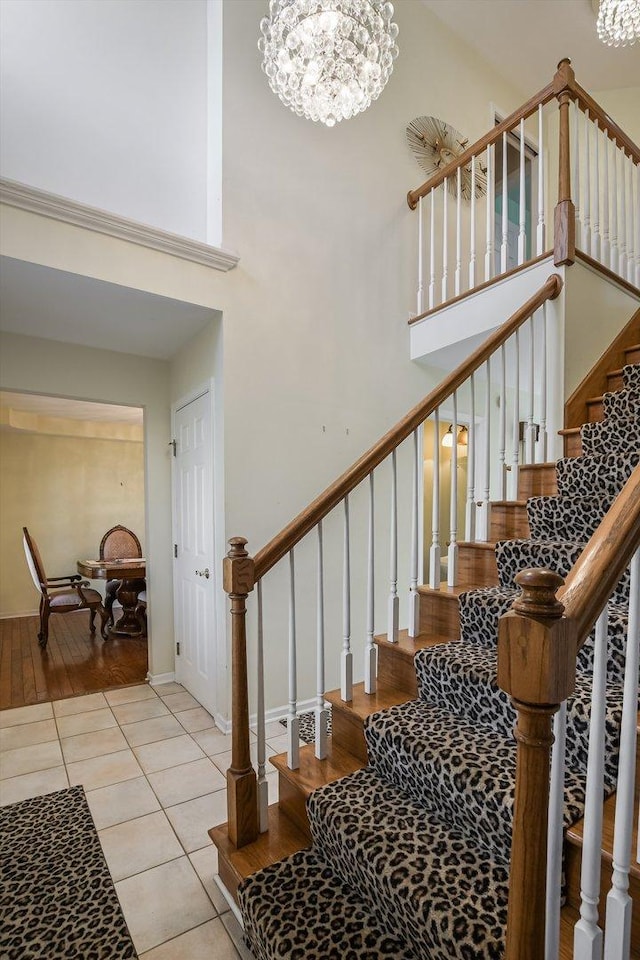 18036 Crystal Ln, Lansing, IL 60438 - stairway with a towering ceiling, a chandelier, and tile patterned flooring
