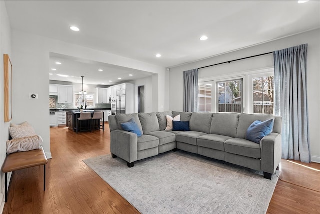 living area with recessed lighting and wood finished floors