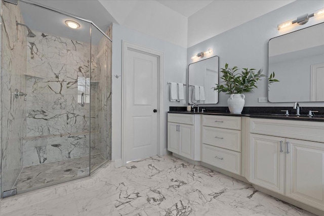 full bath featuring a sink, a marble finish shower, marble finish floor, and double vanity