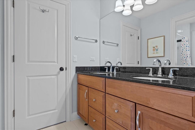 full bath featuring curtained shower, double vanity, and a sink