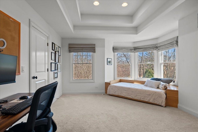 carpeted bedroom featuring recessed lighting, baseboards, and a raised ceiling