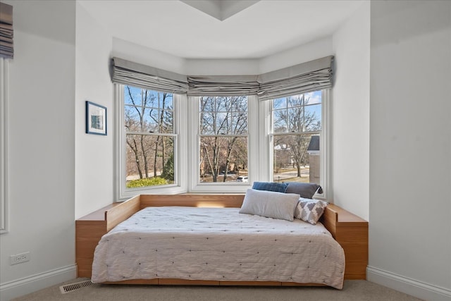 carpeted bedroom featuring visible vents and baseboards