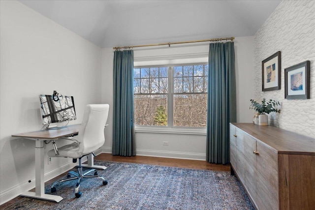 office space featuring wood finished floors, baseboards, and vaulted ceiling