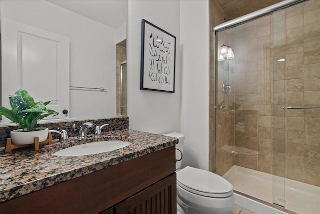 bathroom with vanity, toilet, and a stall shower