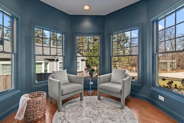living area featuring recessed lighting, baseboards, and wood finished floors
