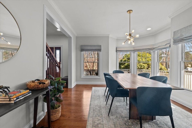 dining area featuring baseboards, stairs, ornamental molding, wood finished floors, and a notable chandelier