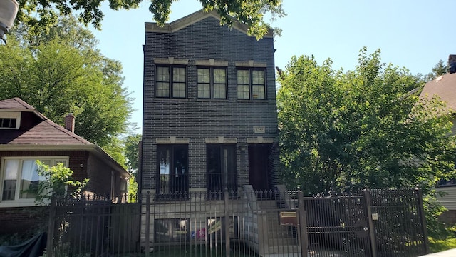 8349 S Constance Ave, Chicago, IL 60617 - view of front facade featuring a gate, brick siding, and a fenced front yard