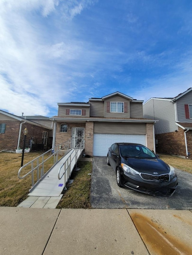 view of front of property with driveway, brick siding, and an attached garage