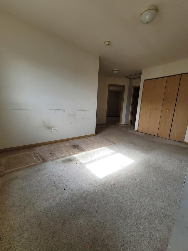 unfurnished bedroom with baseboards and carpet