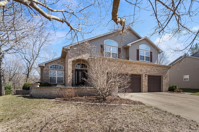 view of front of house with brick siding, driveway, and an attached garage