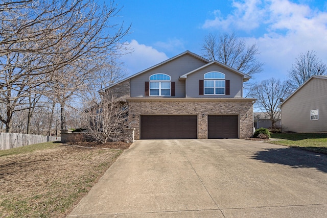 view of front of property featuring brick siding, driveway, fence, and a garage