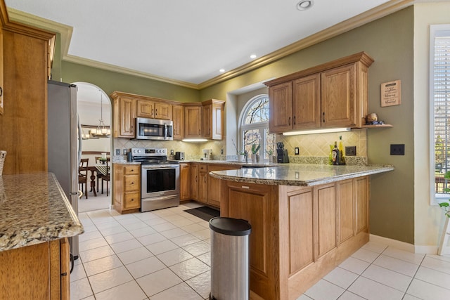 kitchen featuring tasteful backsplash, light tile patterned floors, a peninsula, crown molding, and stainless steel appliances