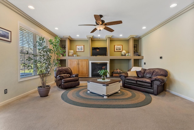 carpeted living room with ornamental molding, baseboards, recessed lighting, and a fireplace