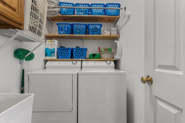 clothes washing area featuring a sink, independent washer and dryer, and laundry area