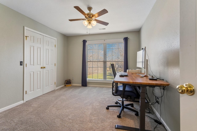 office area featuring carpet flooring, baseboards, a ceiling fan, and visible vents
