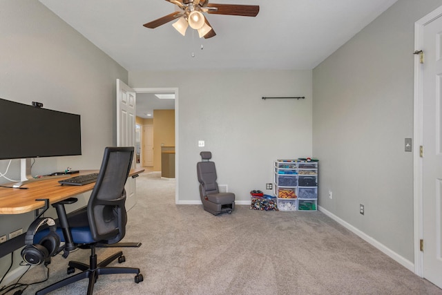 carpeted office with baseboards and ceiling fan