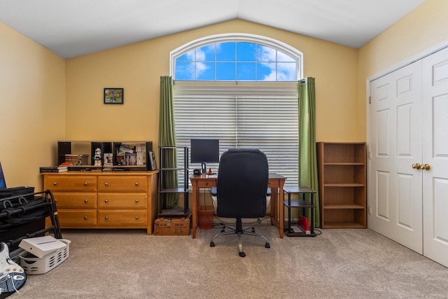 carpeted home office with lofted ceiling