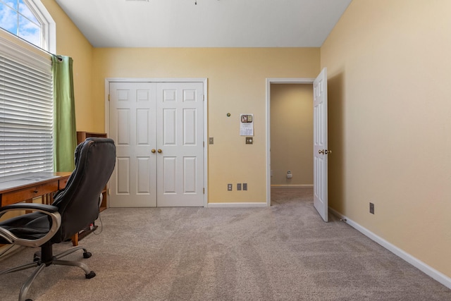 office area featuring baseboards and carpet