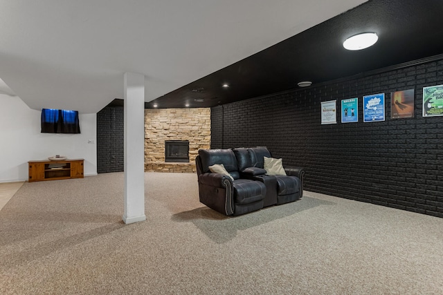 interior space with a stone fireplace and carpet flooring