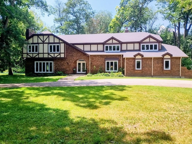 4 Auburn Ln, Barrington Hills, IL 60010 - english style home featuring french doors, a front lawn, a chimney, and brick siding