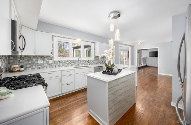 4 Auburn Ln, Barrington Hills, IL 60010 - kitchen featuring stainless steel appliances, tasteful backsplash, light countertops, a kitchen island, and dark wood-type flooring
