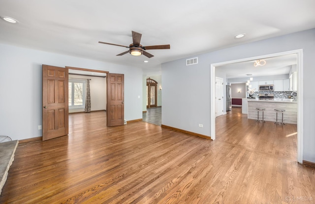 4 Auburn Ln, Barrington Hills, IL 60010 - unfurnished living room with wood finished floors, a ceiling fan, and recessed lighting