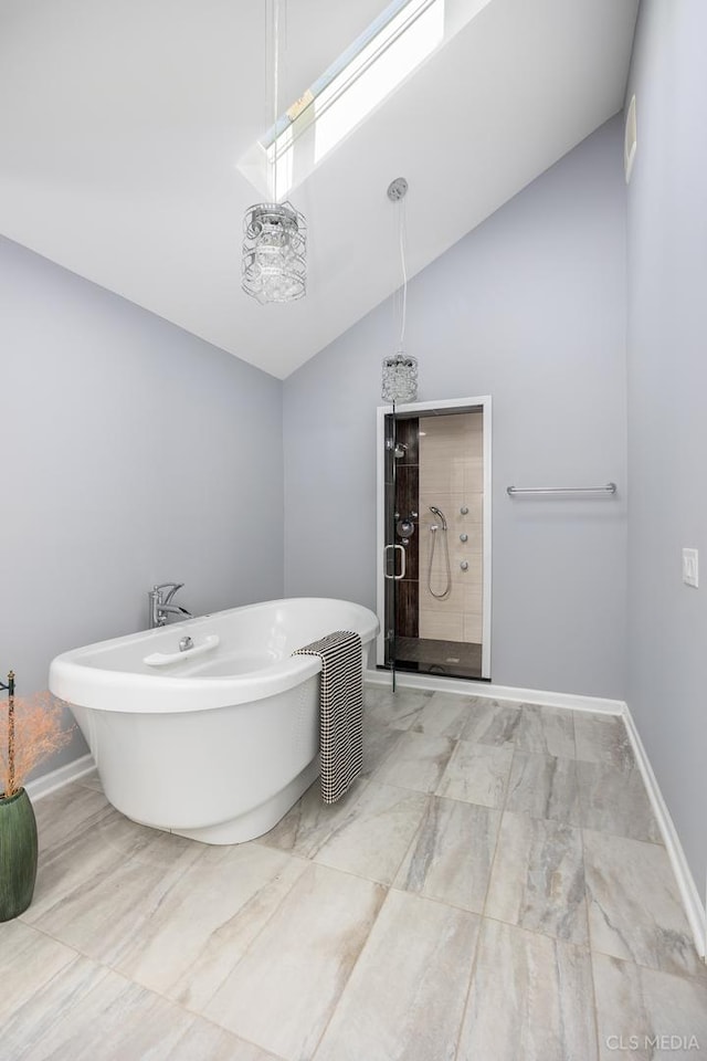 4 Auburn Ln, Barrington Hills, IL 60010 - full bath with tiled shower, vaulted ceiling, a freestanding tub, marble look tiles, and a skylight