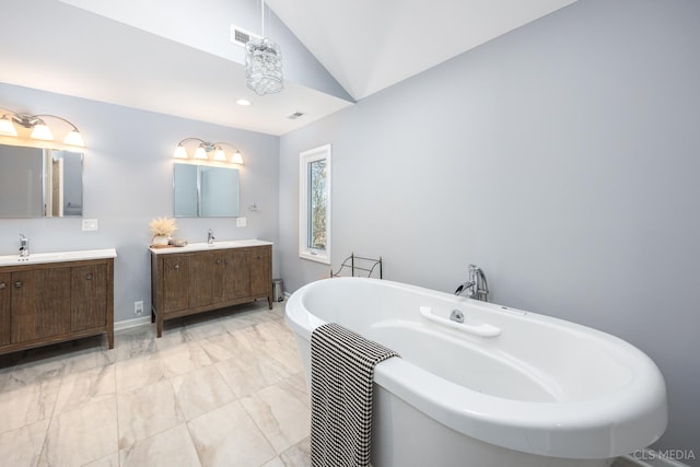 4 Auburn Ln, Barrington Hills, IL 60010 - full bathroom with vaulted ceiling, marble finish flooring, a freestanding tub, and two vanities