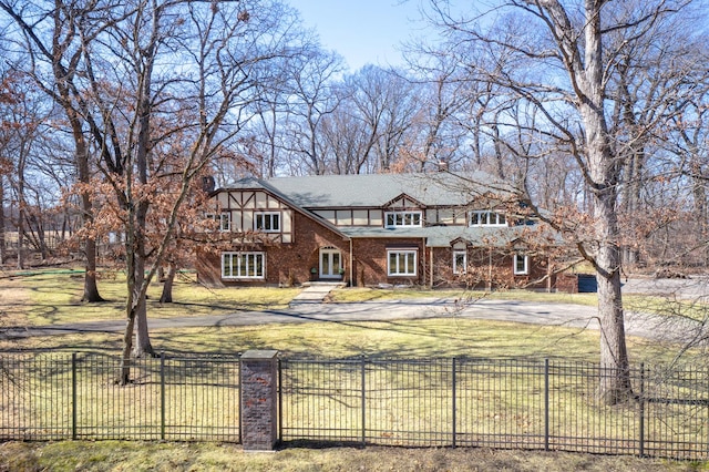 4 Auburn Ln, Barrington Hills, IL 60010 - tudor house with a fenced front yard and brick siding