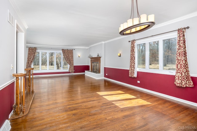 4 Auburn Ln, Barrington Hills, IL 60010 - unfurnished living room featuring wood finished floors, ornamental molding, and a chandelier