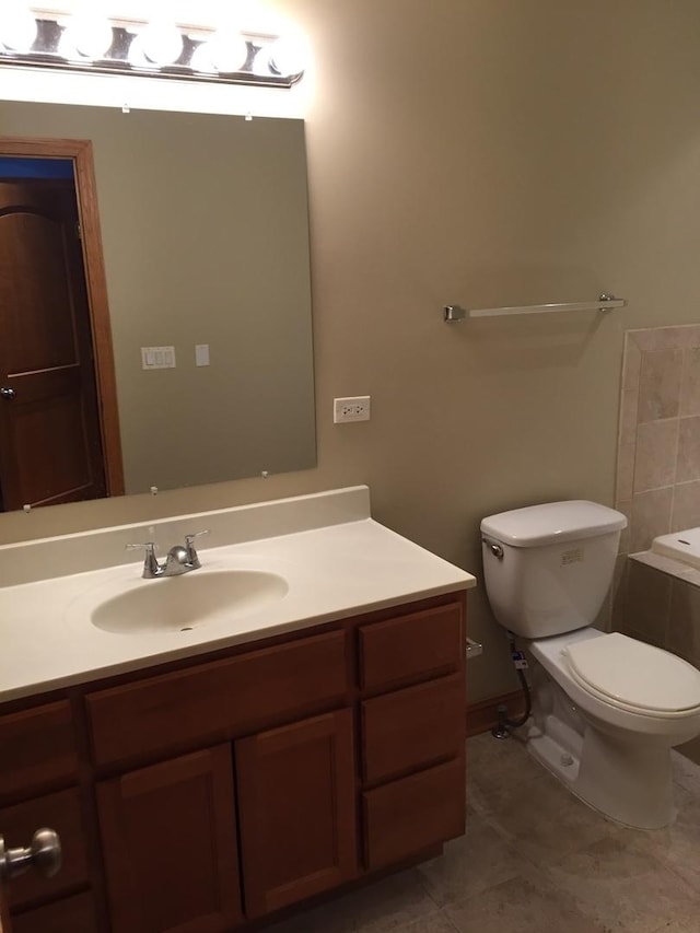 bathroom featuring tile patterned floors, toilet, and vanity