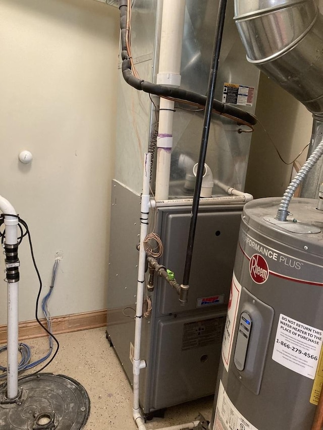 utility room featuring heating unit and electric water heater