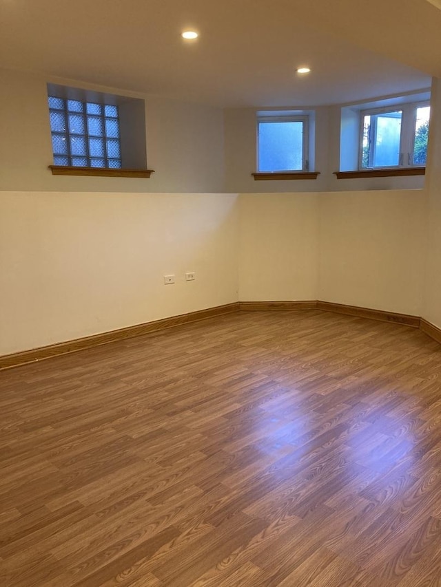 empty room featuring recessed lighting, baseboards, and wood finished floors