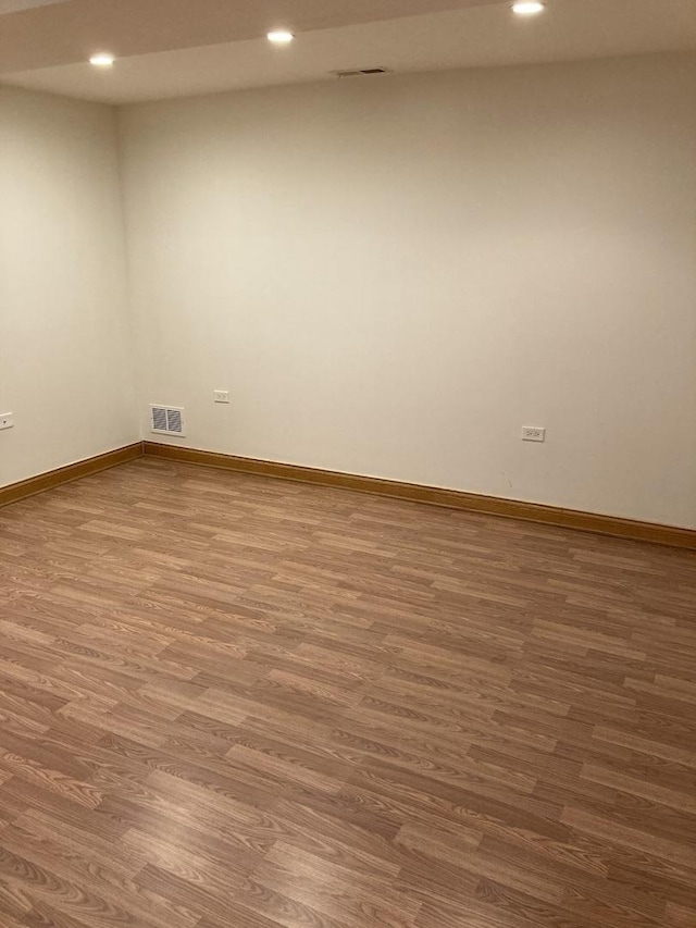 empty room with visible vents, recessed lighting, baseboards, and wood finished floors