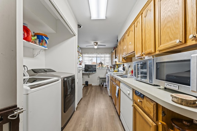 interior space with light wood finished floors, white dishwasher, light countertops, stainless steel microwave, and washing machine and dryer