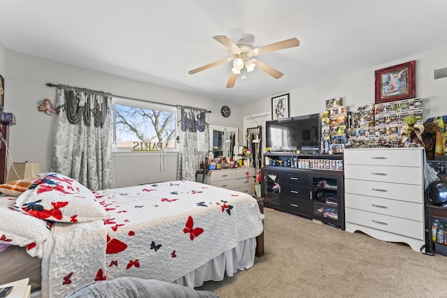 bedroom with visible vents, ceiling fan, and carpet flooring