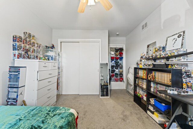 bedroom with visible vents, carpet, a closet, and a ceiling fan