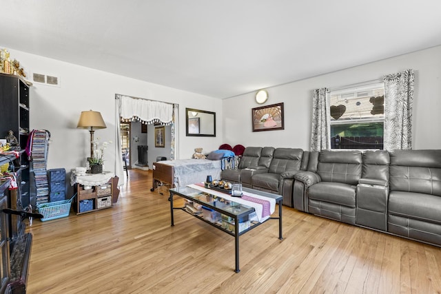 living area featuring visible vents and light wood finished floors