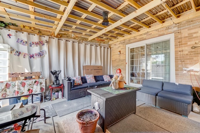 living area featuring brick wall