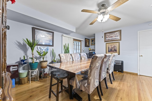 dining room featuring light wood finished floors and ceiling fan