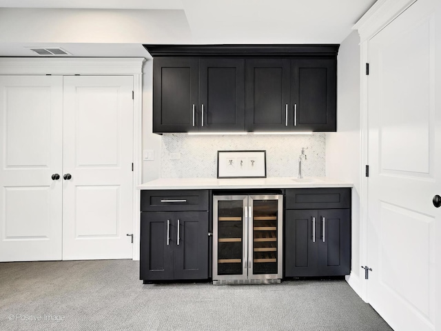 513 W Chicago Ave, Hinsdale, IL 60521 - indoor bar with beverage cooler, light carpet, and tasteful backsplash