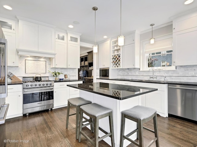 513 W Chicago Ave, Hinsdale, IL 60521 - kitchen featuring stainless steel appliances, a sink, a breakfast bar, backsplash, and white cabinets
