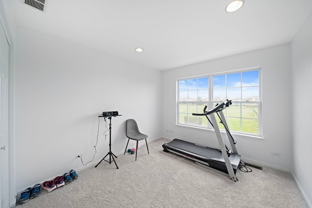workout room featuring carpet flooring, visible vents, and a wealth of natural light